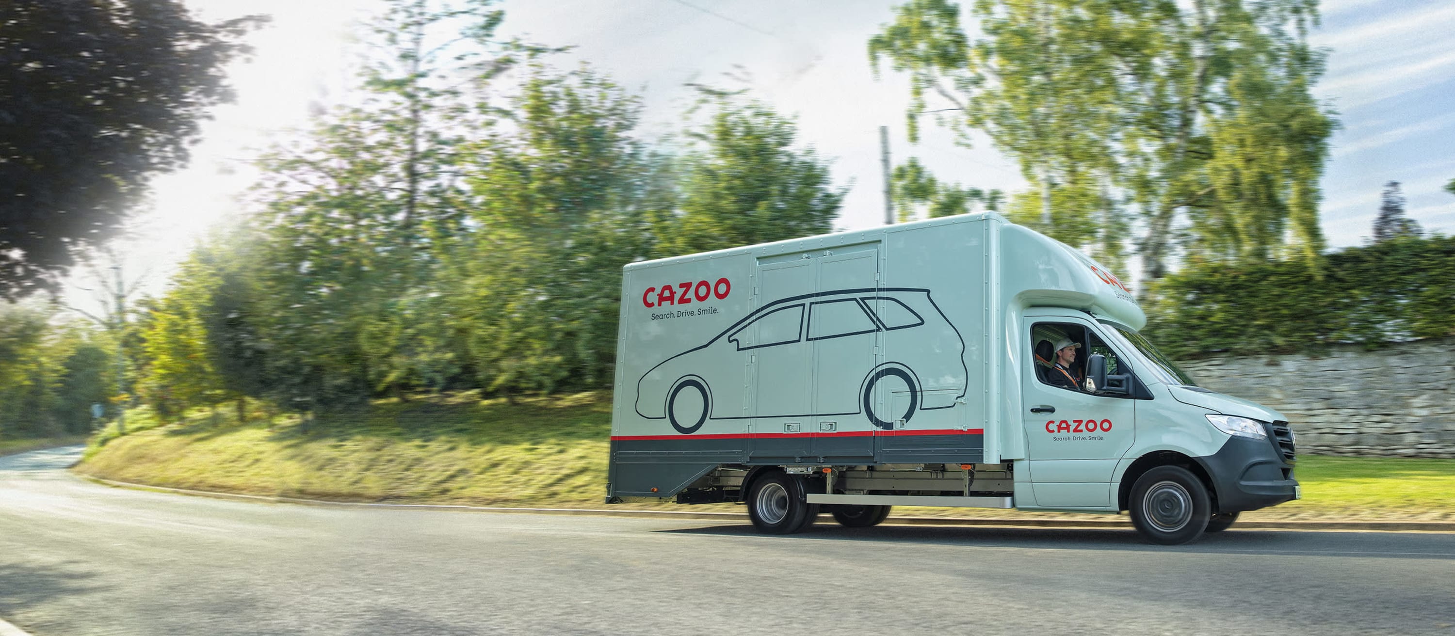 Cazoo delivery truck driving on a road