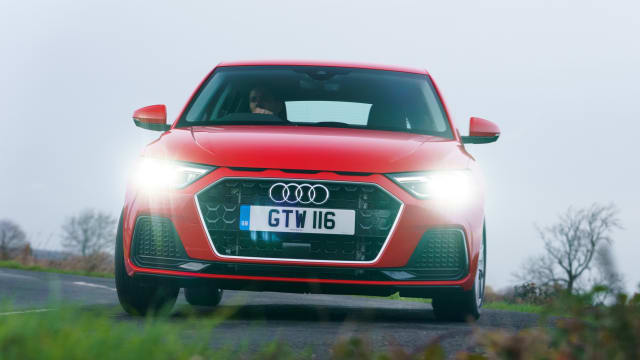 Red Audi A1 Sport driving down a country road