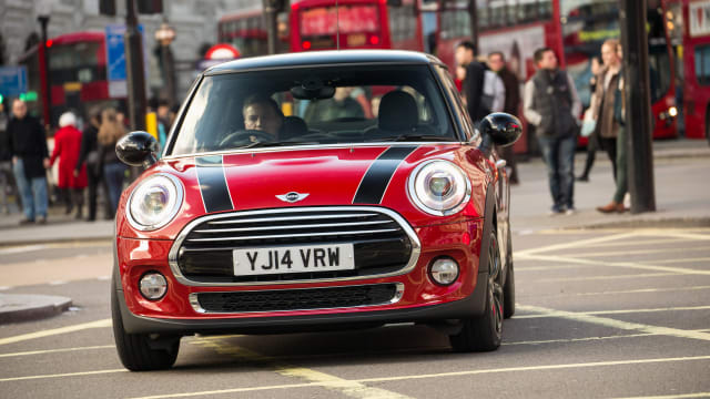 Red Mini Hatch driving along a London street